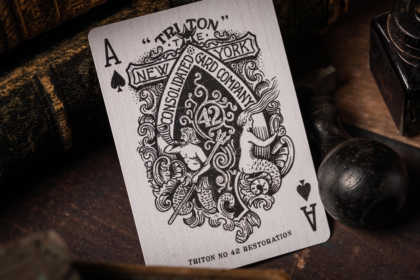 Playing card with intricate design and text on a wooden surface