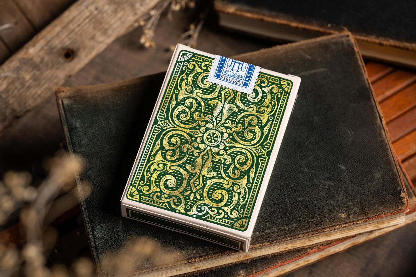 gold gilded luxury playing cards - collectable limited edition - premium playing cards resting on antique book