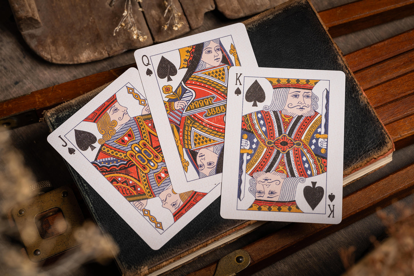 vintage playing cards - spade courts - resting on old book