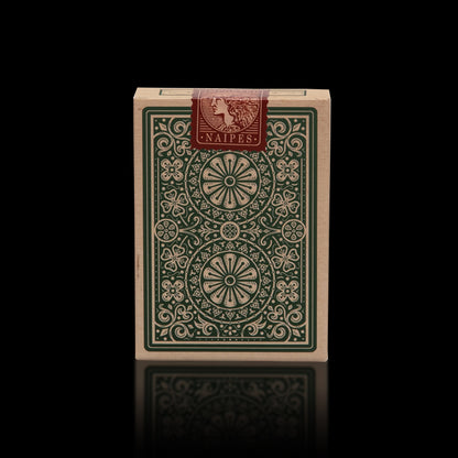 Stock image showing the back of Imported Playing Cards tuck box and red seal featuring the word Naipes. The tuck box has an aged effect with green printed detailing. 