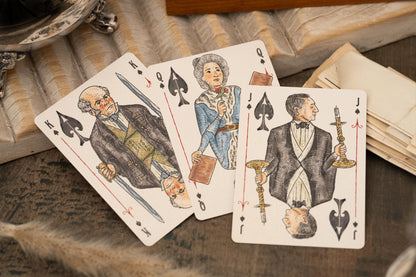 Vintage Love & Retribution illustrated character courts playing cards with intricate designs on a textured surface