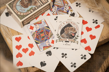Playing cards with a vintage design on a wooden surface