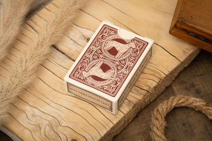 Playing card box with intricate design on a wooden surface