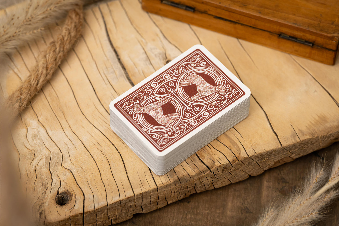 Playing cards with red and white design on a wooden surface