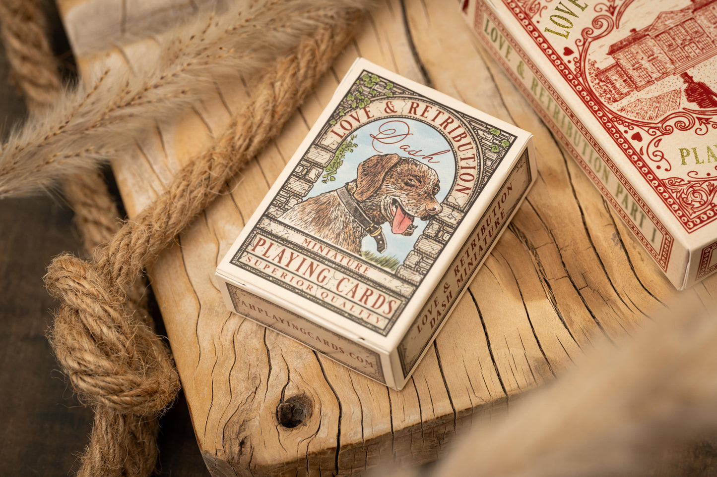 Playing card box with a dog illustration on a wooden surface