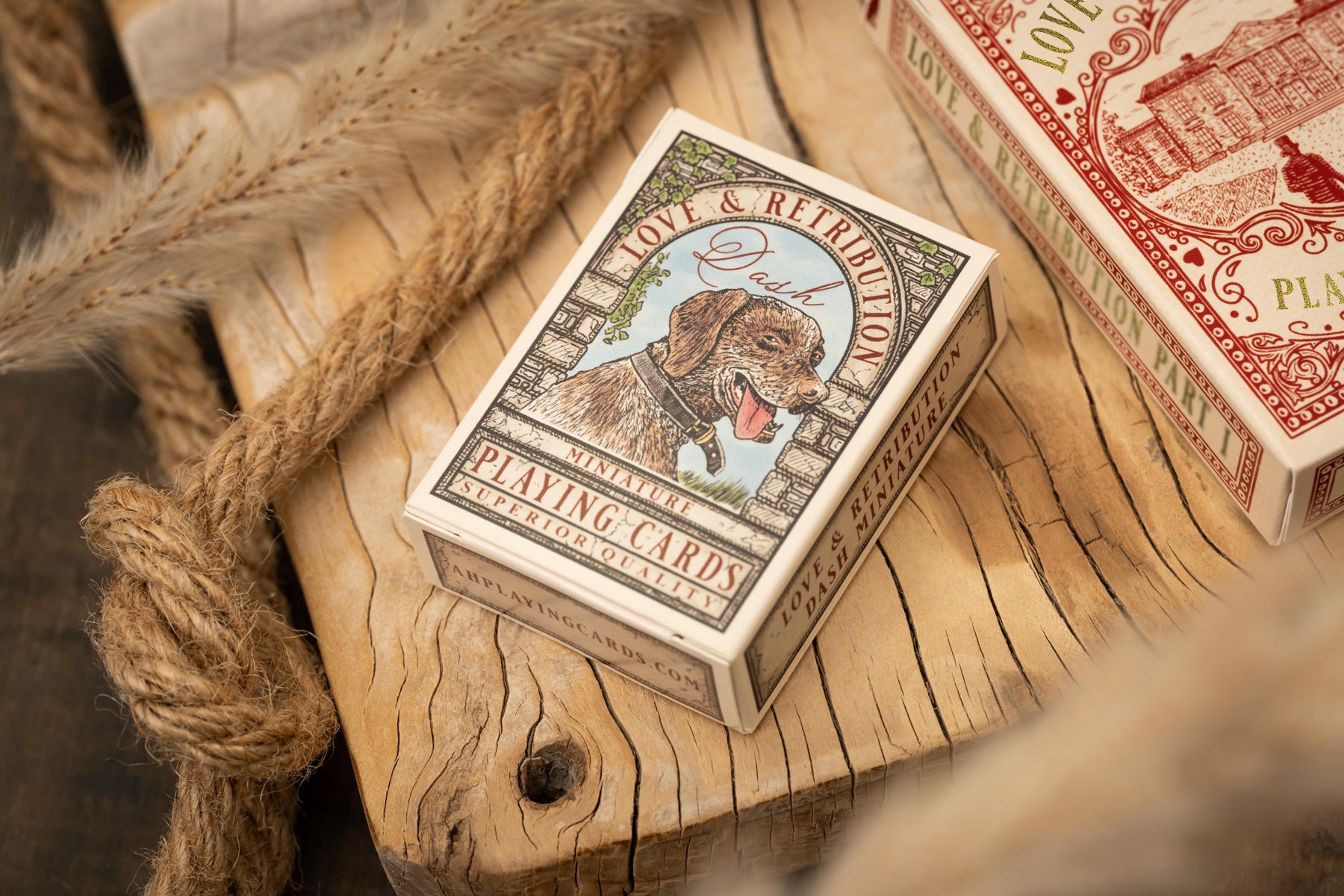 Playing card box with a dog illustration on a wooden surface