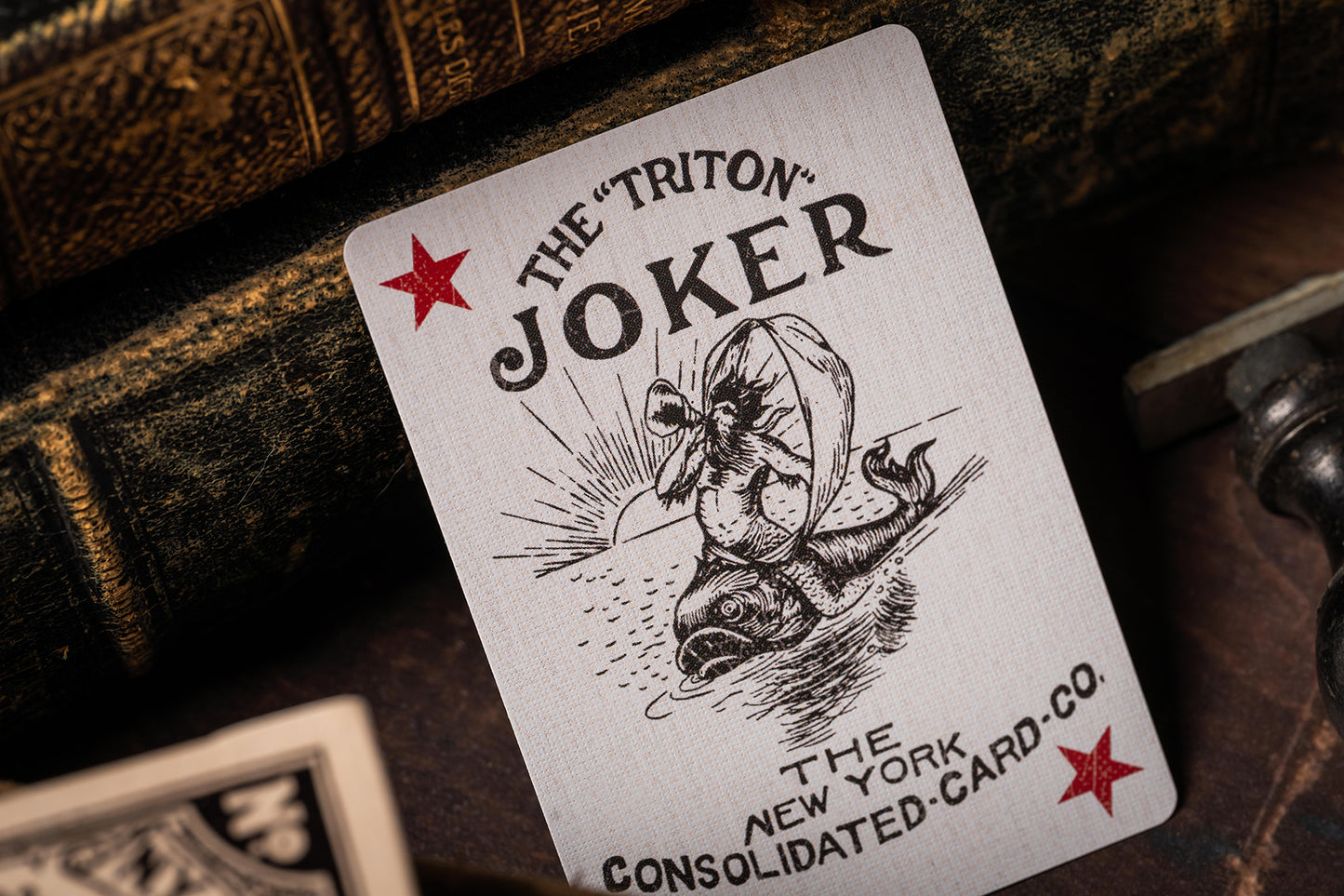 Playing card with 'The Triton Joker' design on a dark background