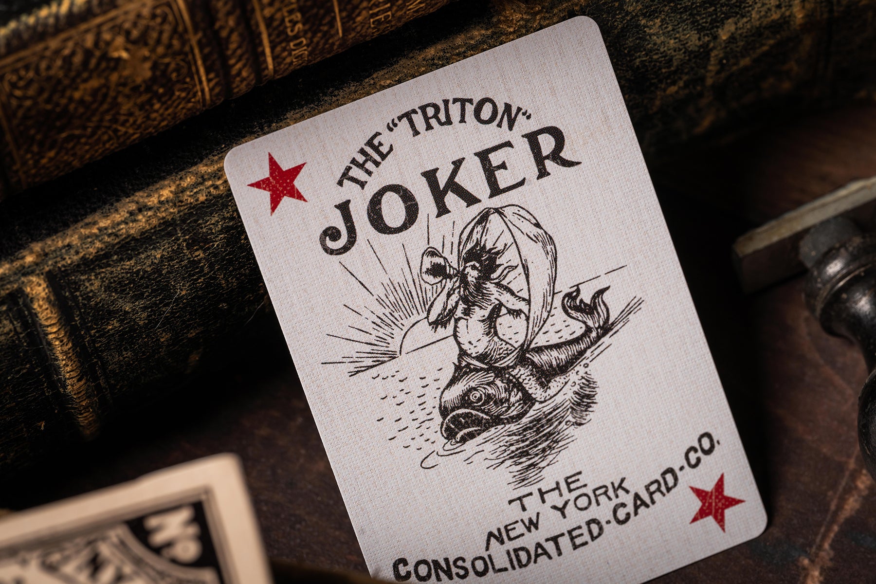 Playing card with 'The Triton Joker' design on a dark background