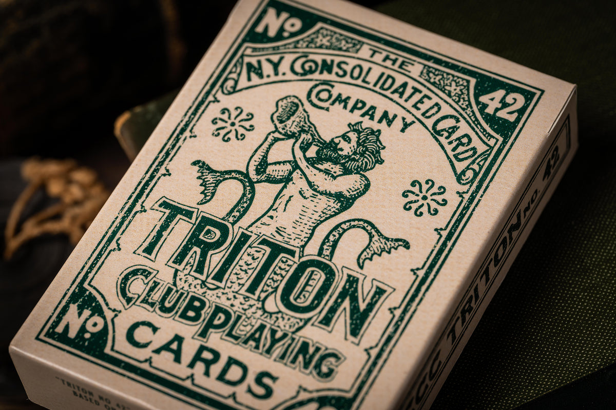 Triton Club playing cards with green and white design on a dark background and vintage tuckbox