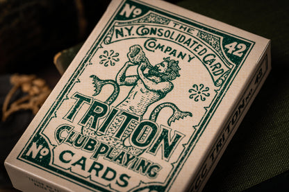 Triton Club playing cards with green and white design on a dark background and vintage tuckbox