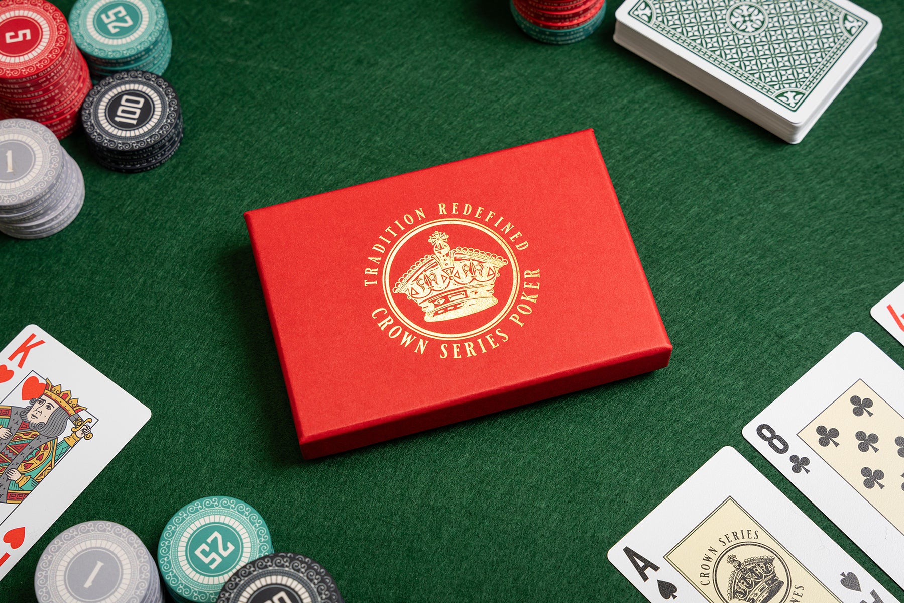 crown series poker pvc casino playing cards in luxury foiled gift box - with poker chips - playing a hand of poker on green felt gaming table