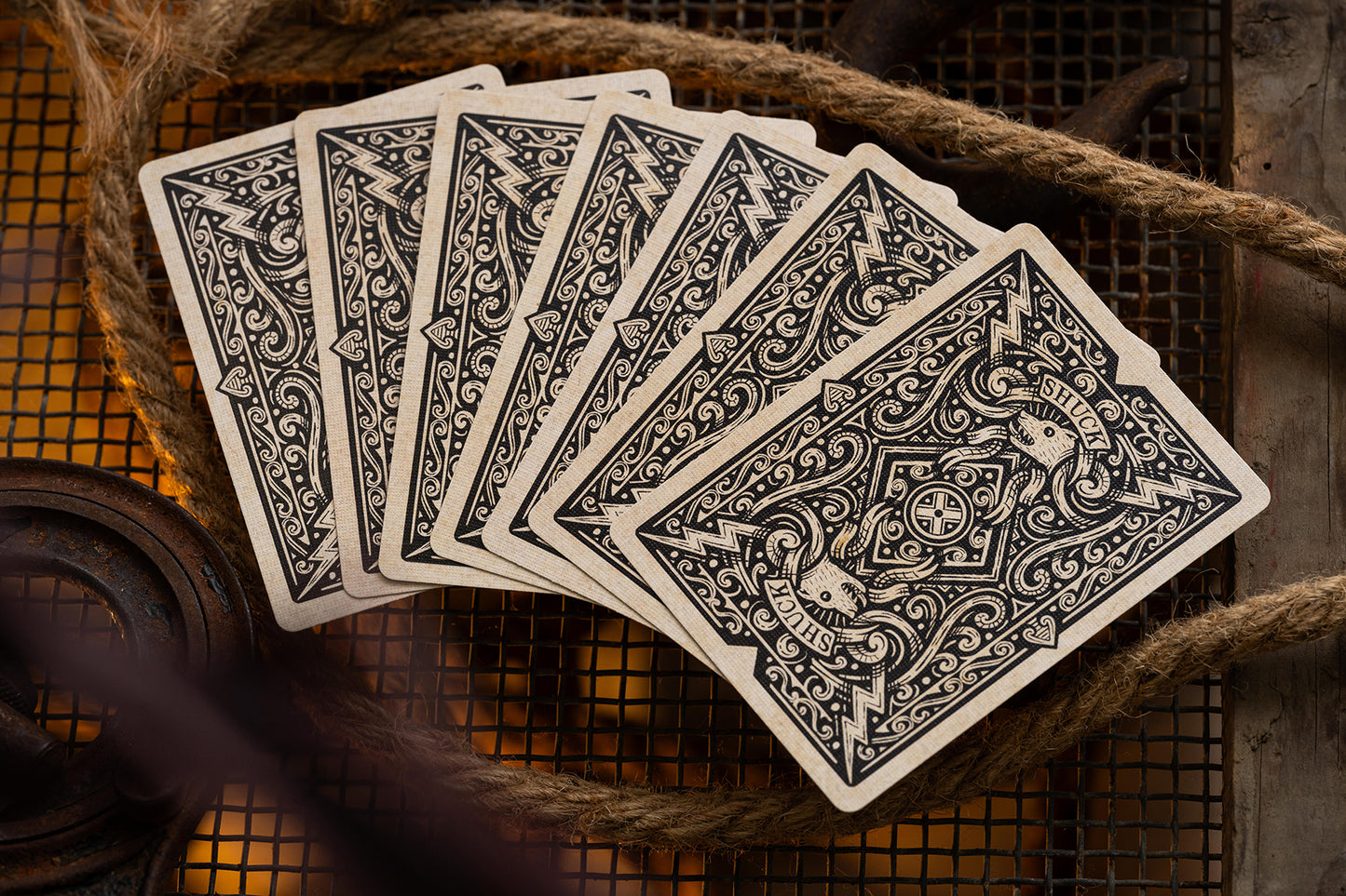 Set of vintage british cryptid black shuck playing cards with intricate designs on a rustic background