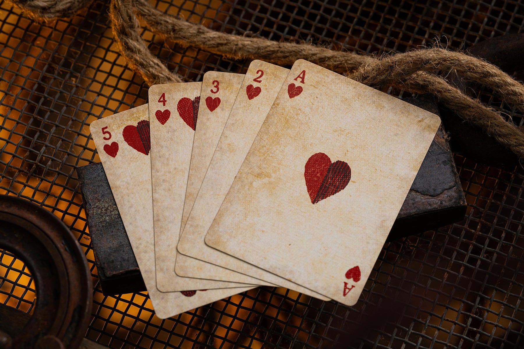 Set of vintage playing cards with heart symbols on a rustic background