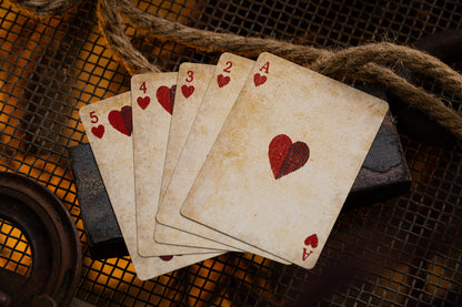 Set of vintage playing cards with heart symbols on a rustic background