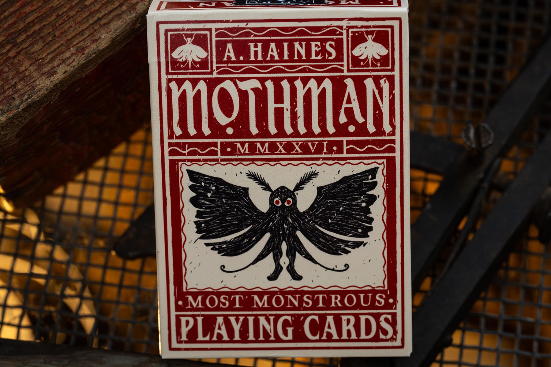 premium playing card tuckbox with Mothman design and text on a textured background - uk playing cards - hand-drawn