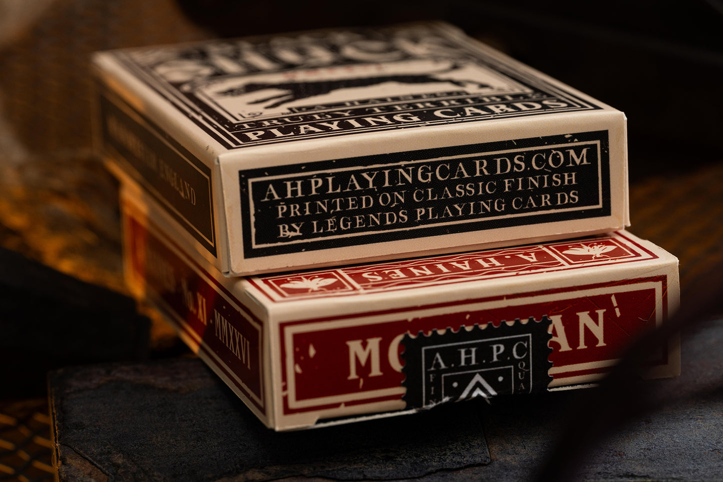 Two boxes of playing cards with vintage cryptids branding on a dark background