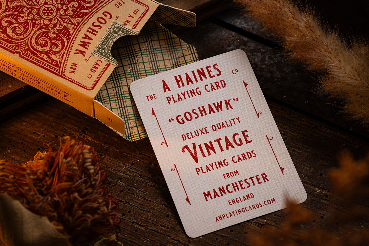vintage goshawk playing cards plaid pattern tuckbox a haines resting on woodgrain