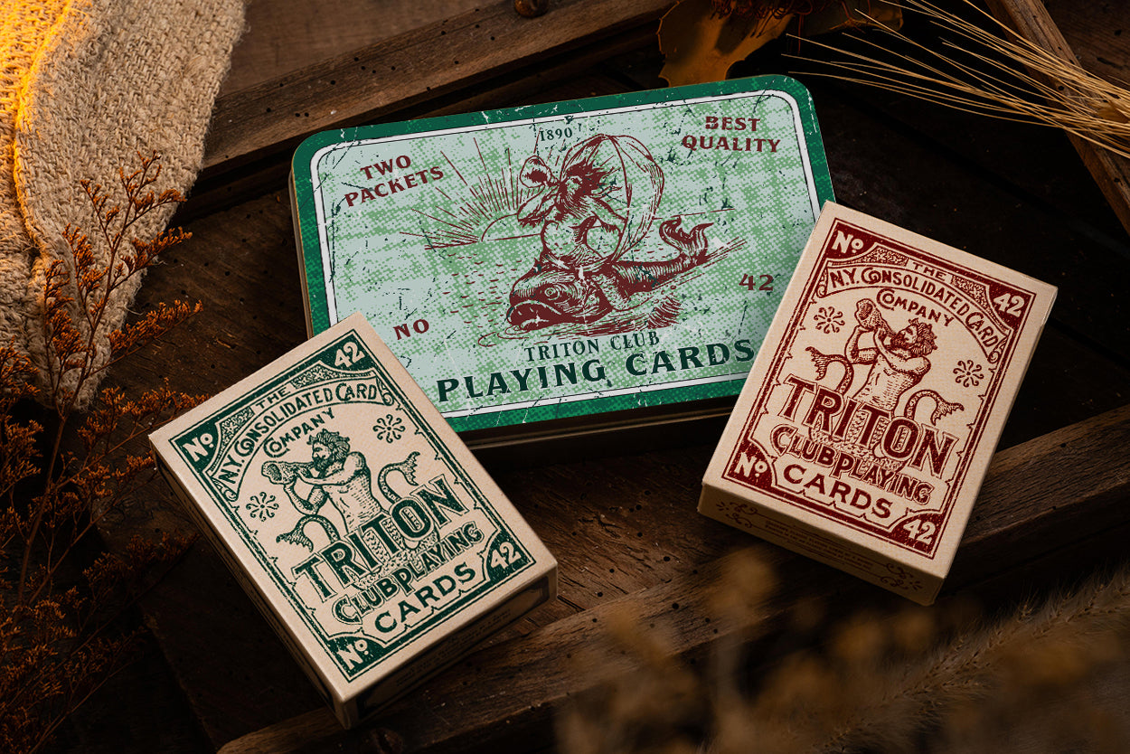 Triton 42 collectors tin open showing two decks of playing cards in laser-cut foam insert