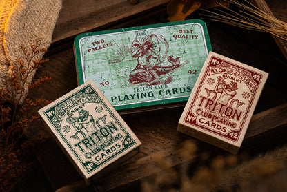 Triton 42 collectors tin open showing two decks of playing cards in laser-cut foam insert