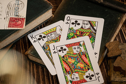 Imported Playing Cards. Image shows King of Clubs, Queen of Clubs and Jack of Clubs. All hand drawn original courts based on the traditional courts found in many playing card decks. Sticking with the vintage theme this deck is photographed with old books, stamps and postcard props. 