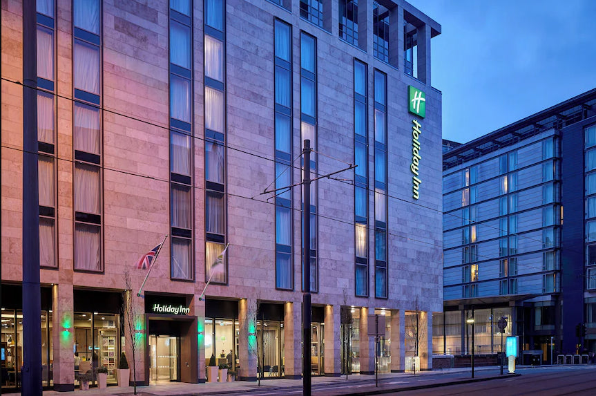 Holiday Inn manchester central - hotel exterior at dusk with illuminated sign -  cards in common uk playing card convention venue 2026